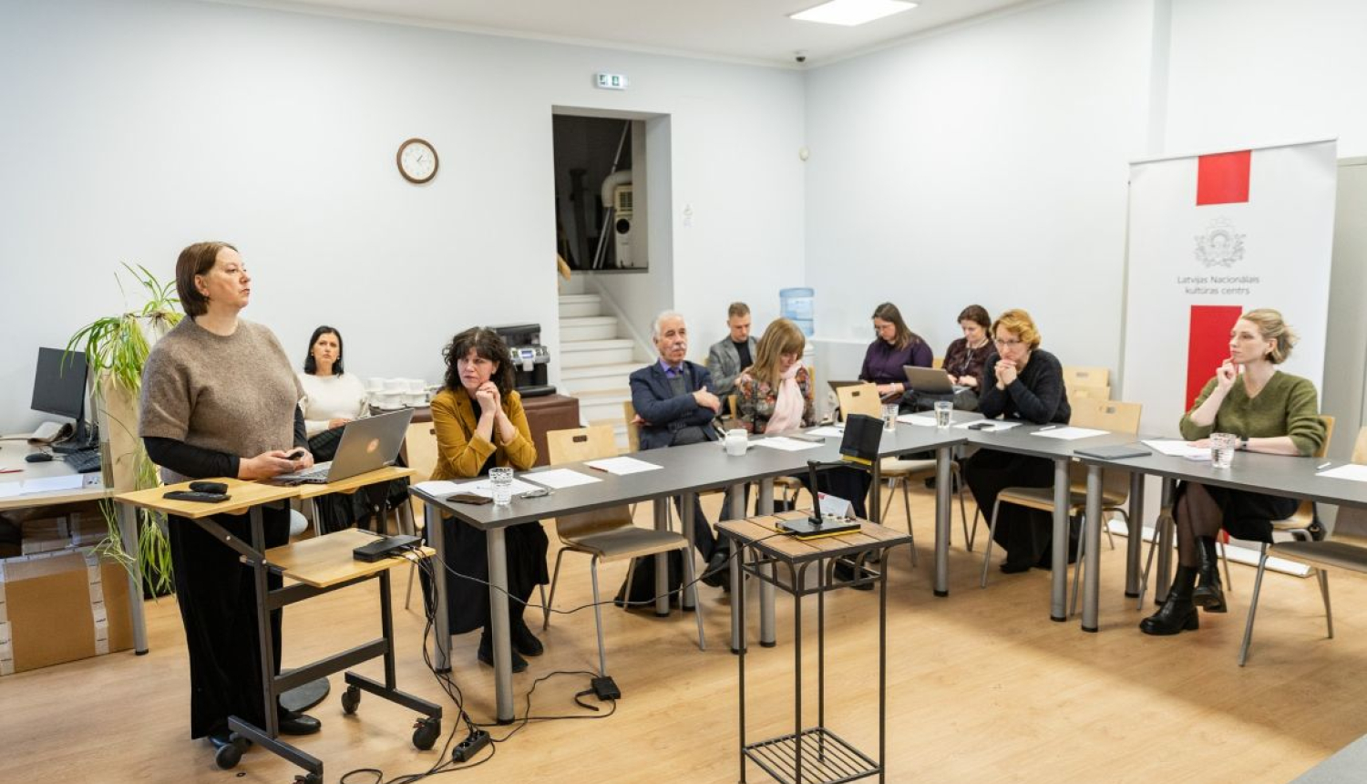Dziesmu un deju svētku padomes sēdes locekļi sēž pie U veida galda Latvijas Nacionālajā kultūras centrā